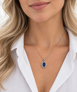 14K White Gold blue sapphire and natural diamond pendant worn on a model