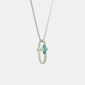 Side view of 14K White Gold blue zircon and natural diamond cross pendant
