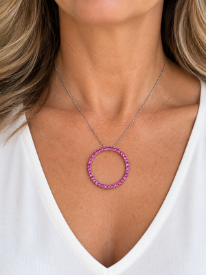 14K White Gold pink sapphire circle pendant worn on a model
