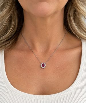 14K white gold ruby and diamond halo necklace worn on model
