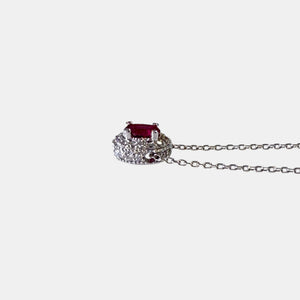Side view of 14K white gold ruby and diamond halo necklace