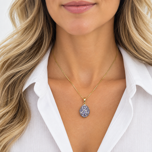 14K Yellow Gold tanzanite and natural diamond pendant worn on a model