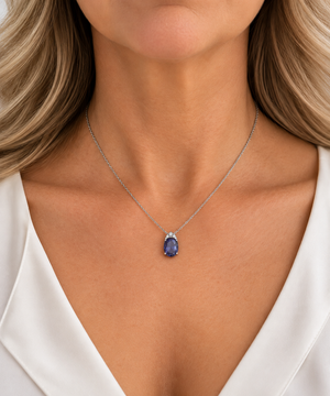 18K White Gold iolite and natural diamond pendant worn on a model