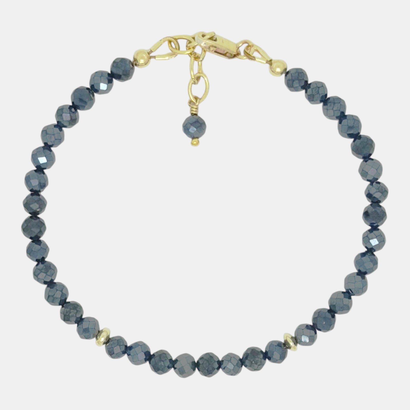 Coated black spinel bracelet with faceted 4 mm gemstones, gold-filled accents, and an adjustable lobster clasp.