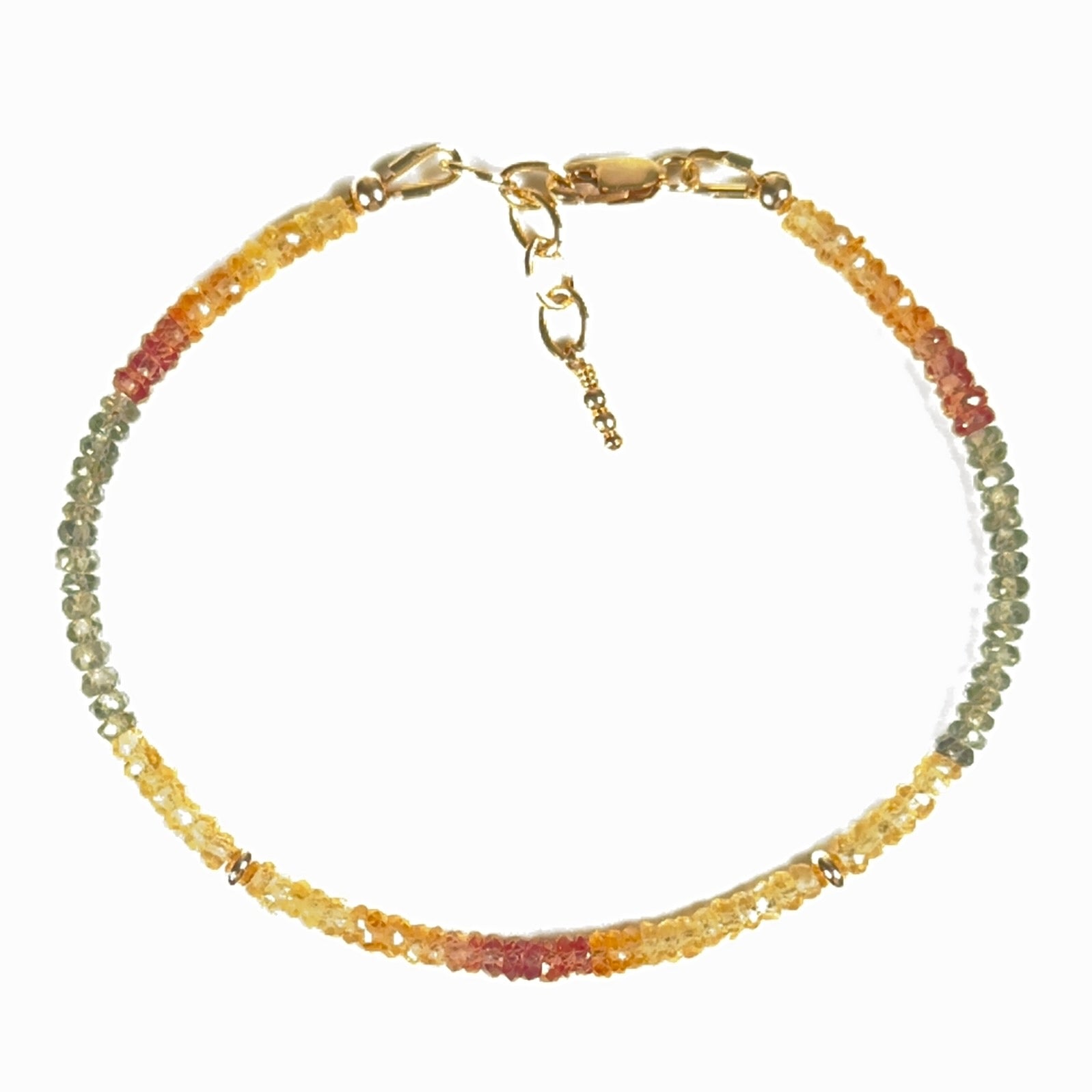 Faceted natural multicolor sapphire bracelet in orange, green and golden tones with gold-filled accent beads, lobster clasp and chain.