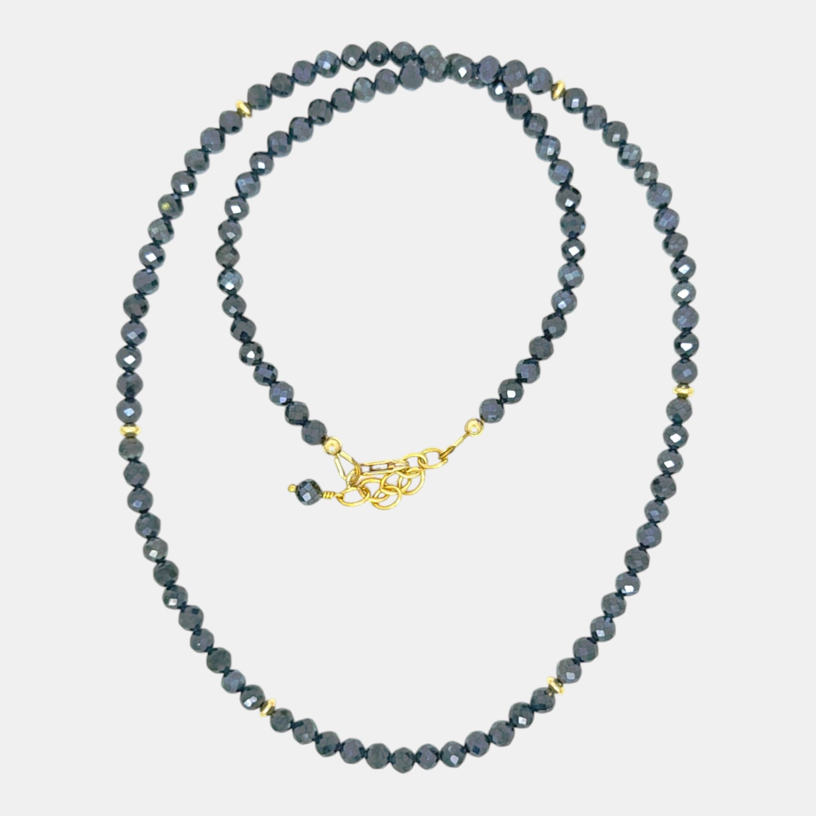 Coated black spinel necklace with faceted 4.2 mm gemstones, gold-filled accents, and an adjustable lobster clasp.