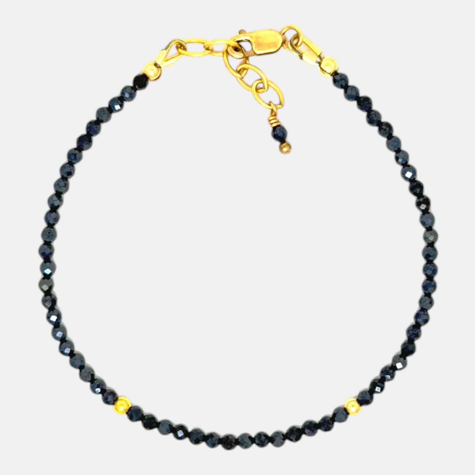Micro-faceted coated black spinel bracelet with 2.4 mm gemstones, gold filled accents and an adjustable 6¾ to 7½ inch length.