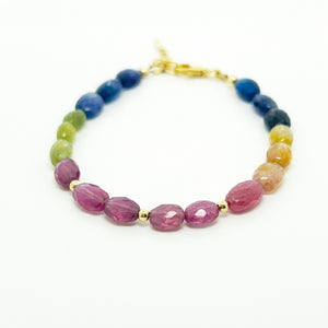 Multicolor sapphire bracelet with large faceted blue, pink, yellow and orange beads shown from a second angle